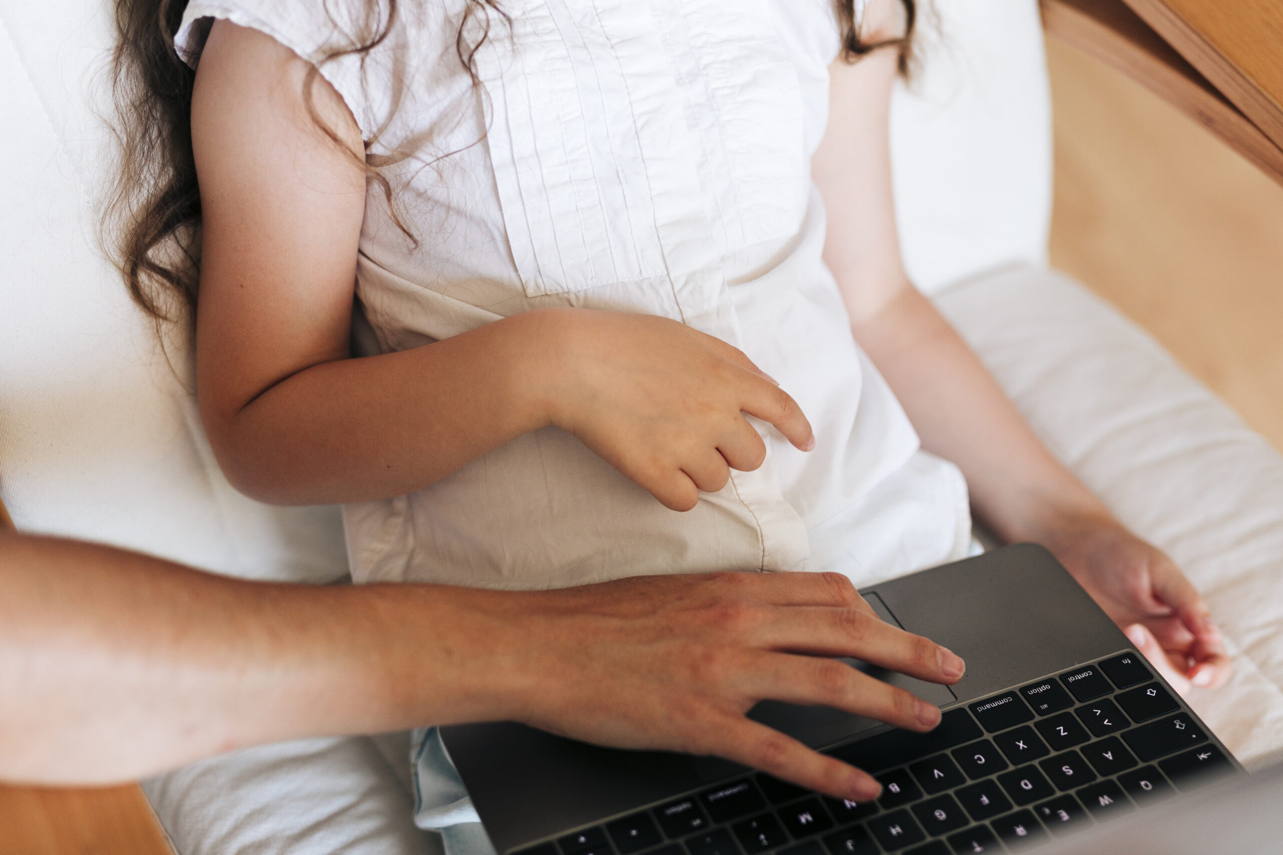 close-up-girl-with-parent-looking-laptop
